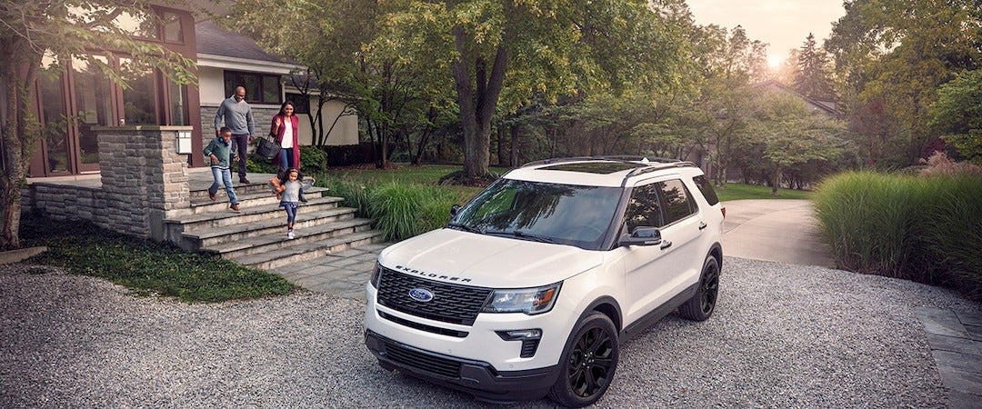 image of a family going to a white Ford SUV
