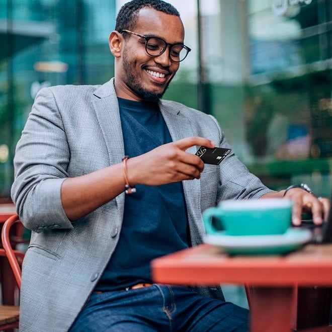 image of a man looking at a credit card