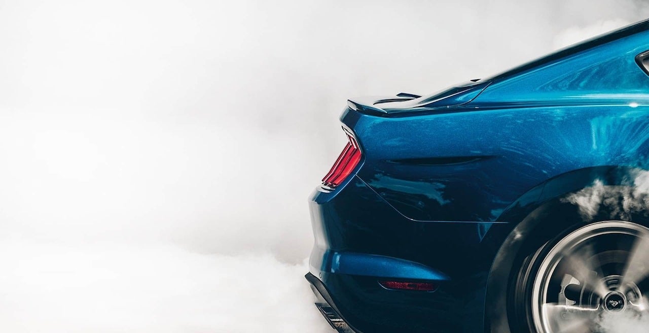 side view image of the back of a car in motion