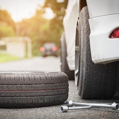 image of a tire on the ground next to a car