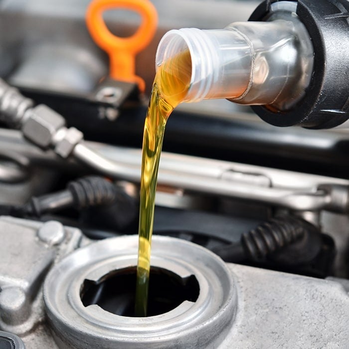 image of oil being poured into an engine
